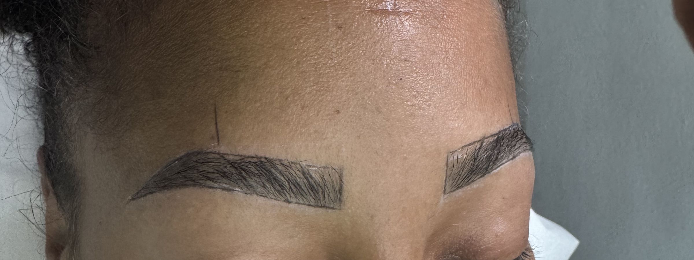 A client with freshly shaped semi-permanent brows
