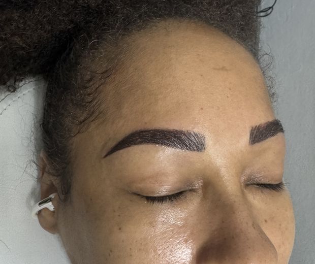 Close-up of microshaded brows on a client resting in the treatment chair