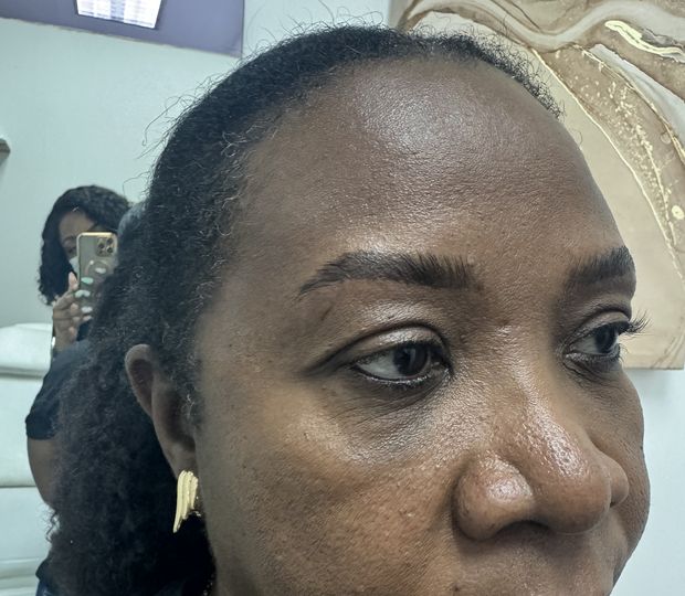 A client after her brow lamination and tint, inside the studio